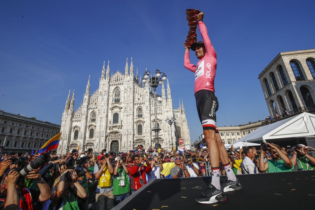 Tom Dumoulin holds his newly won Giro d'Italia trophy high.
