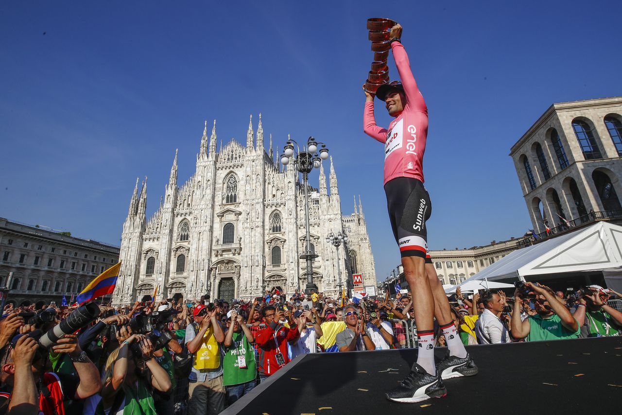 Tom Dumoulin holds his newly won Giro d'Italia trophy high.