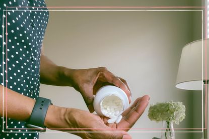 A colse up of a woman decanting paracetamol tablets into her hand