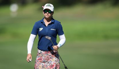 Ewart Shadoff walks with her putter in hand