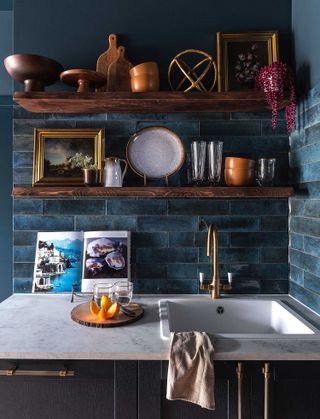 open shelves in a dark blue kitchen