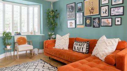 green living room with orange sofa