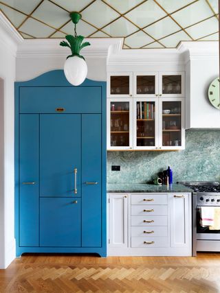 kitchen with blue cabinet and patterned ceiling
