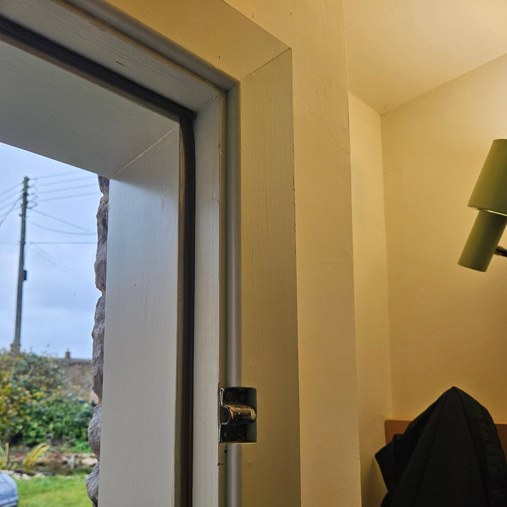 blue door frame with brown draught excluder tape