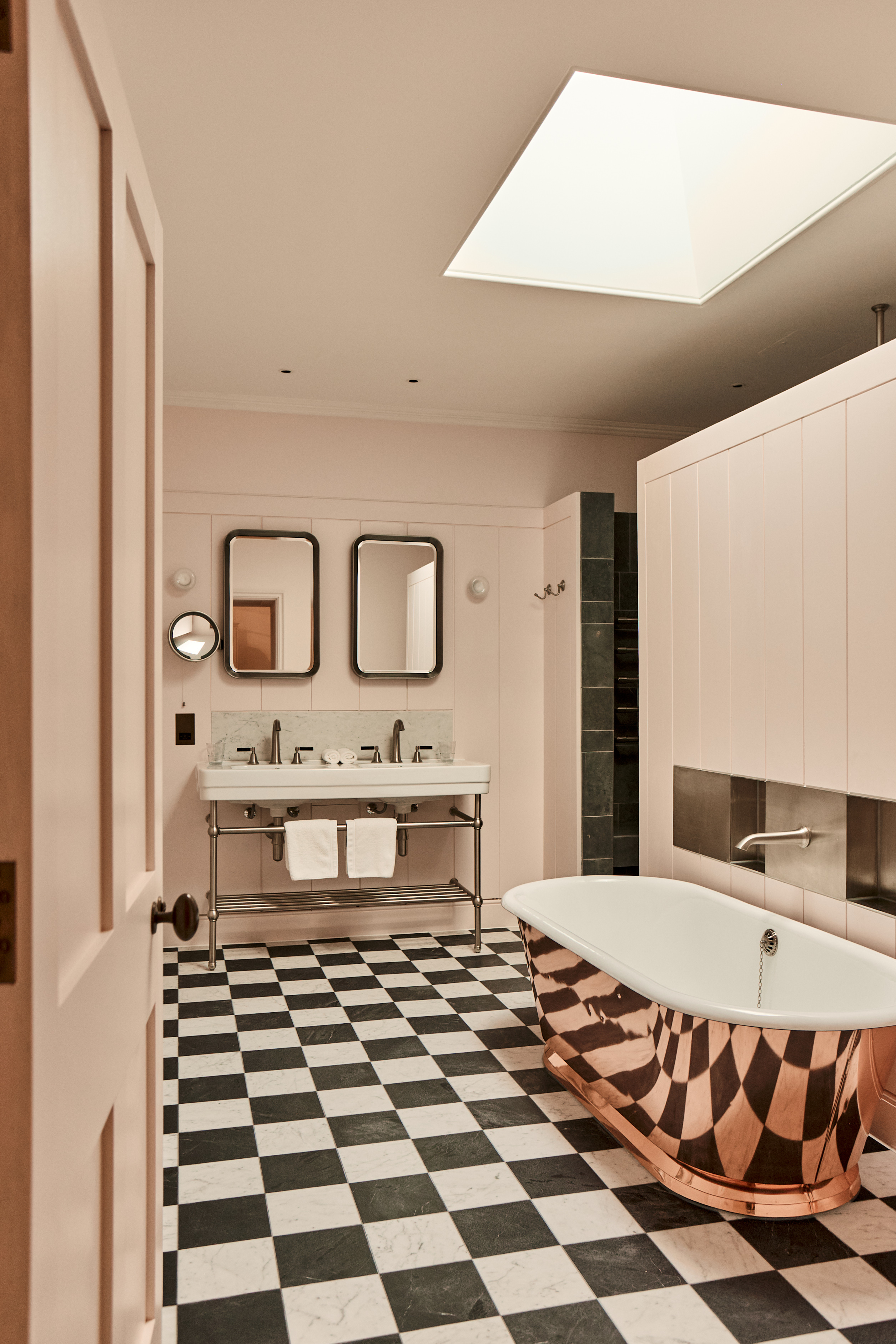 view of a modern bathroom with a rose gold bathtub
