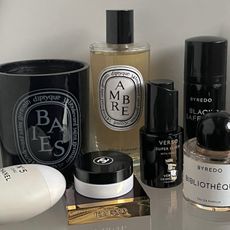 Diptyque and Byredo perfumes on a shelf