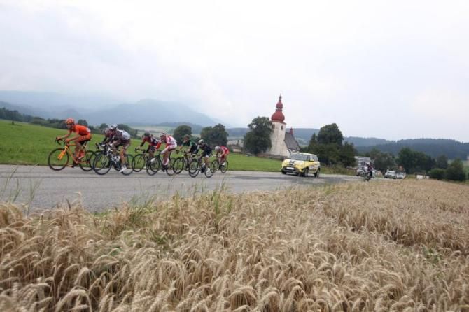 Fields of grain sway in the breeze as the peloton passes