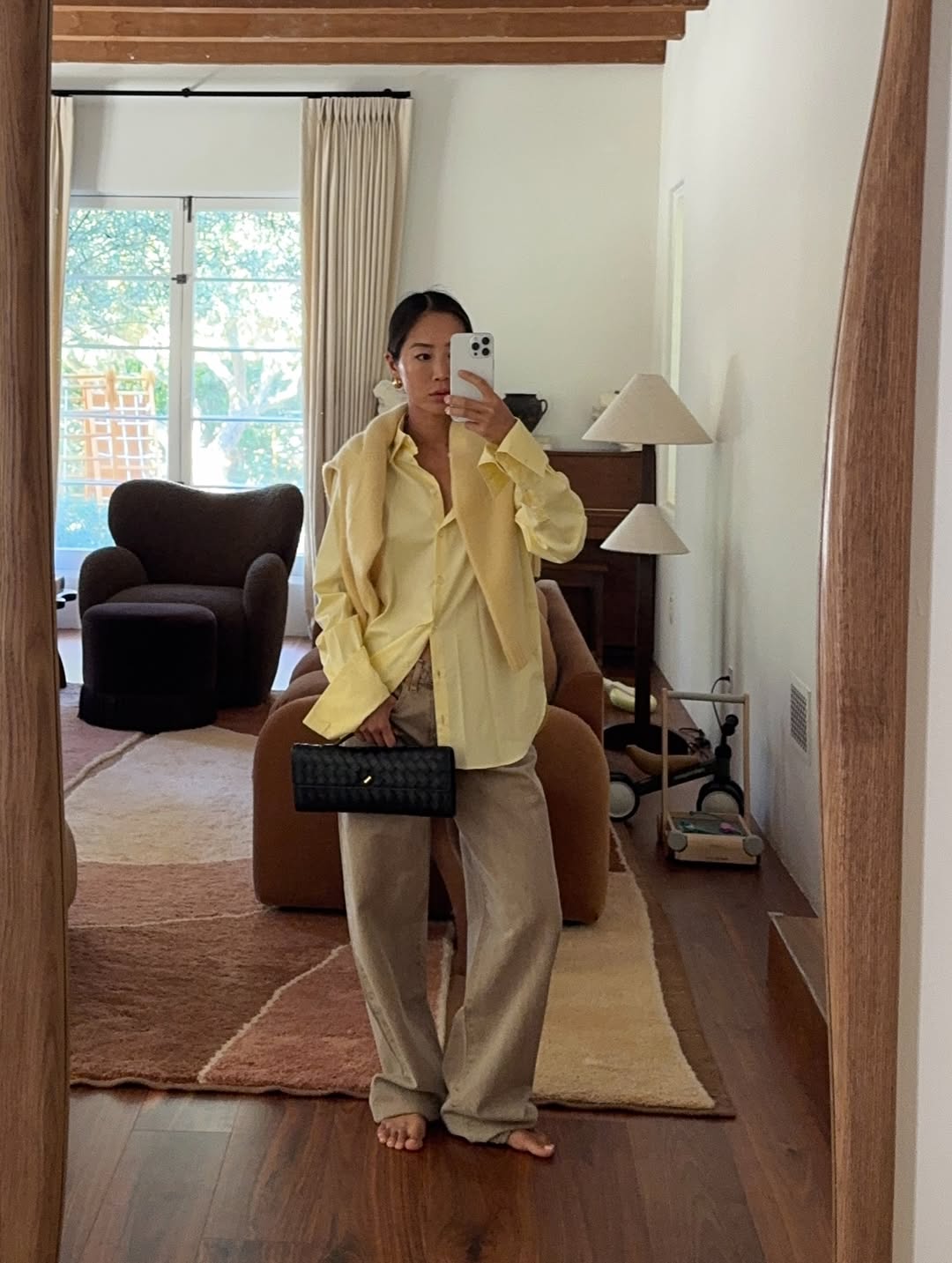 @aimeesong wearing a butter yellow jumper over a shirt