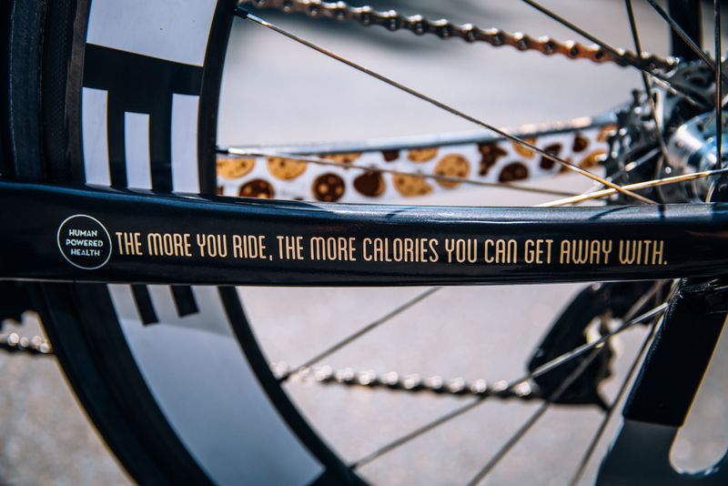 "The more you ride, the more calories you can get away with" Motivational words on Milk and cookies decals on the top tube for Phil Gaimon's bike