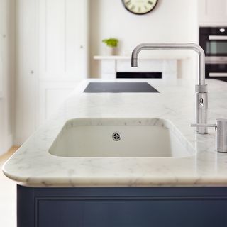 washbasin with marble worktop and tap