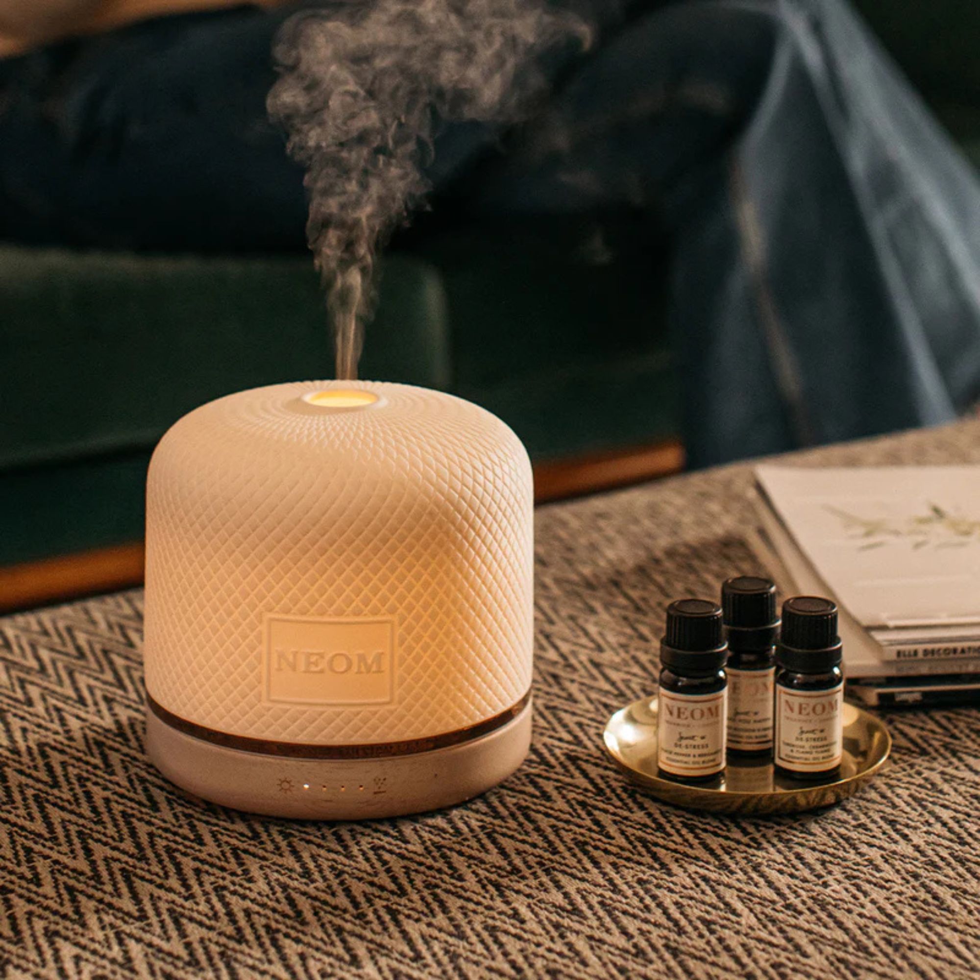 NEOM Wellbeing Pod Luxe on a coffee table.