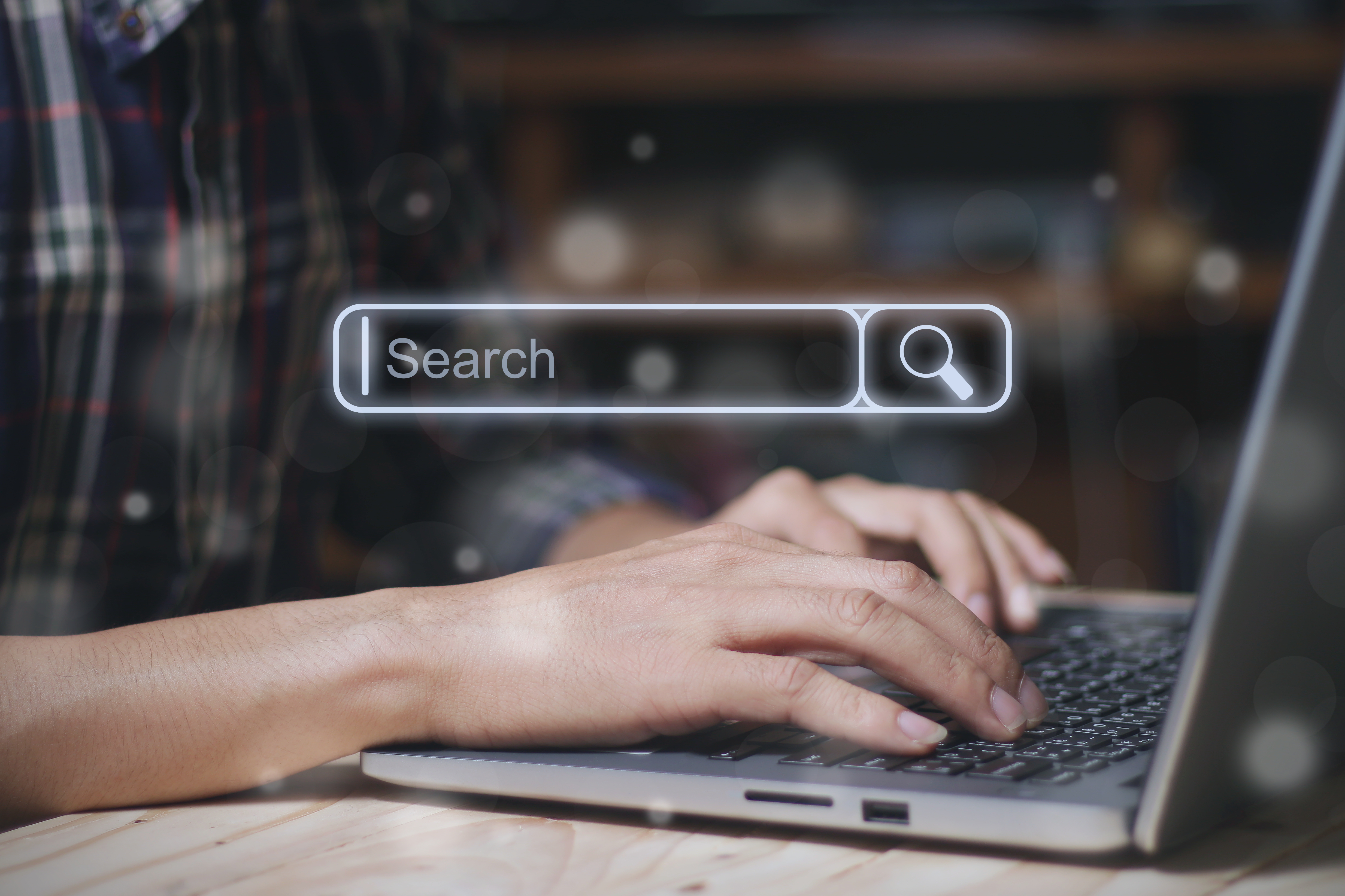 Search bar of internet browser and businessman working on modern laptop at table indoo