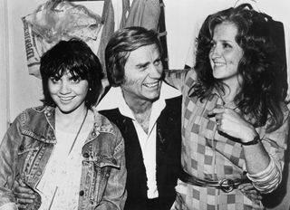 Linda Ronstadt and Bonnie Raitt join country star George Jones backstage at the Bottom Line in September 1980 in New York City, New York