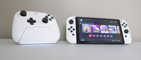 8BitDo Ultimate Controller in white next to an OLED Nintendo Switch