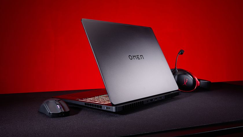 An OMEN laptop, along with HyperX mouse and headset.