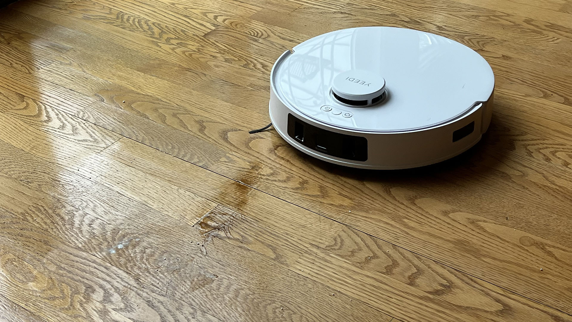 Yeedi M12 Ultra Plus robot vacuum after a single pass, during the soy sauce cleaning test