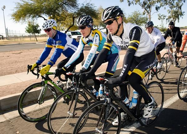 Bjorn Selander, right, and Janez Brajkovic share the road with a sponsor.