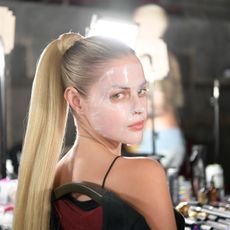 model with face mask backstage