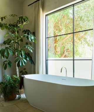 LA bathroom with freestanding tub under window