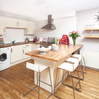 kitchen with wood flooring and wooden platform with kitchen hood and microwave