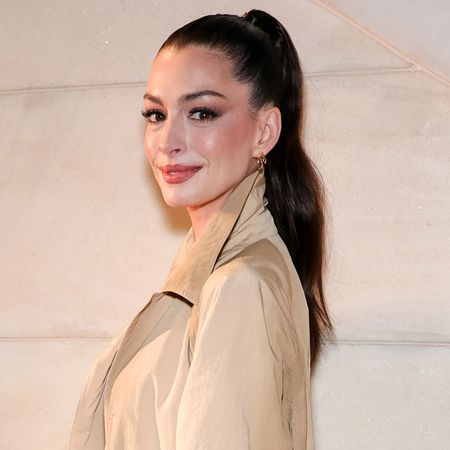 Anne Hathaway channeled Taylor Swift in a gray pleated mini skirt from Thom Browne and Mary Janes