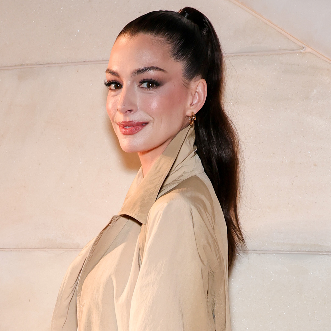 Anne Hathaway channeled Taylor Swift in a gray pleated mini skirt from Thom Browne and Mary Janes