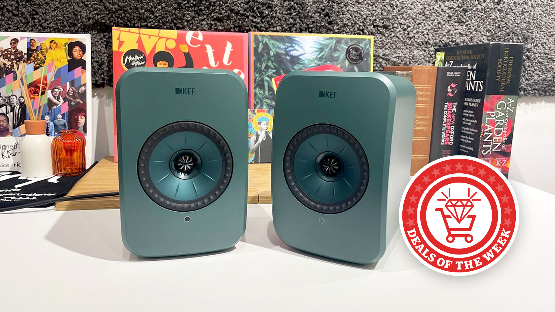 KEF LSX II LT in green on a white desk 