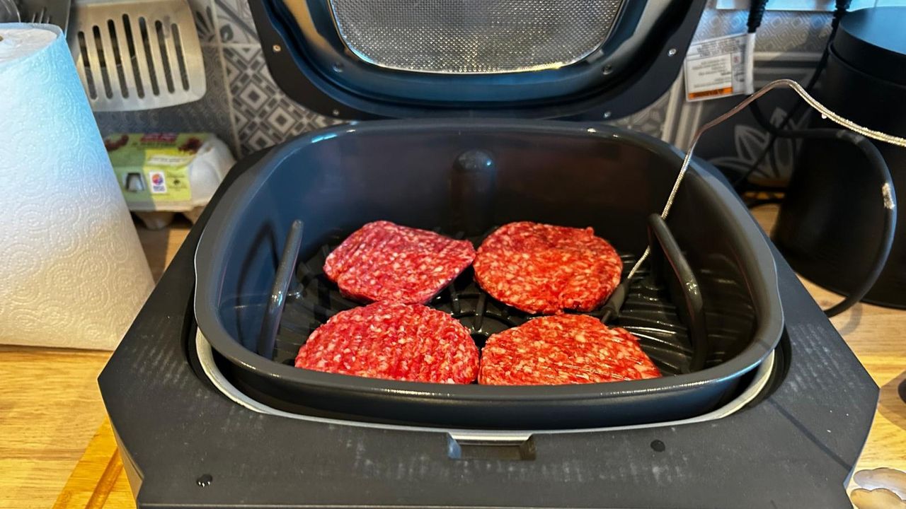 Uncooked burgers in Ninja 5-in-1 Grill and Air Fryer