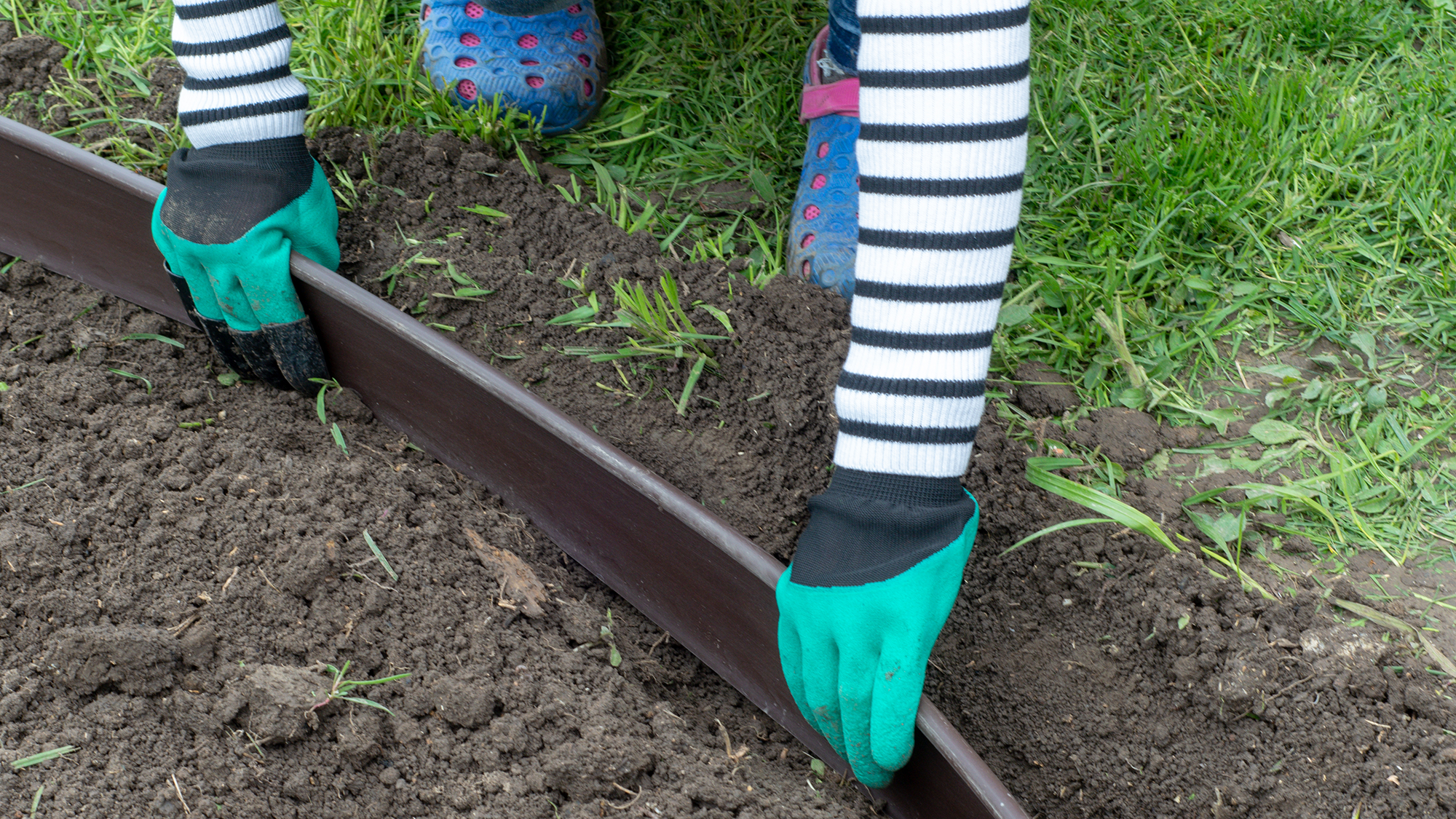 Woman laying garden edging