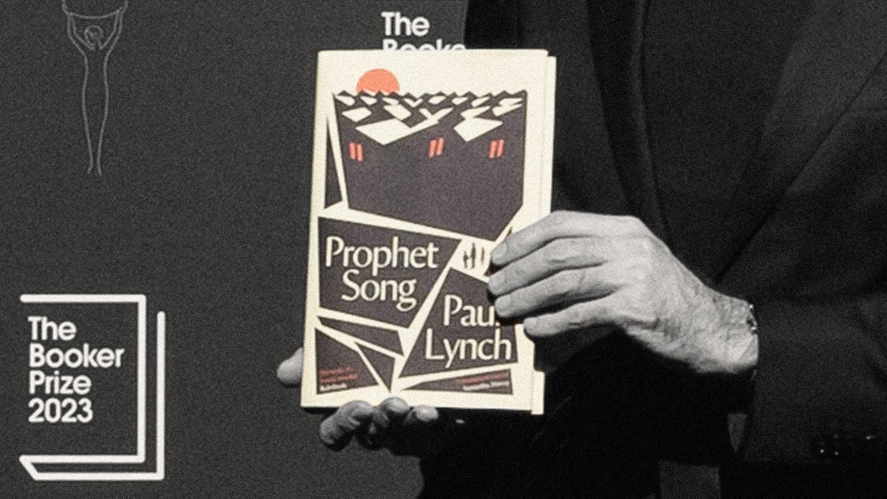 A closeup of Paul Lynch&#039;s hands holding up his book, &quot;Prophet song&quot;, at the Booker Prize awards 2023