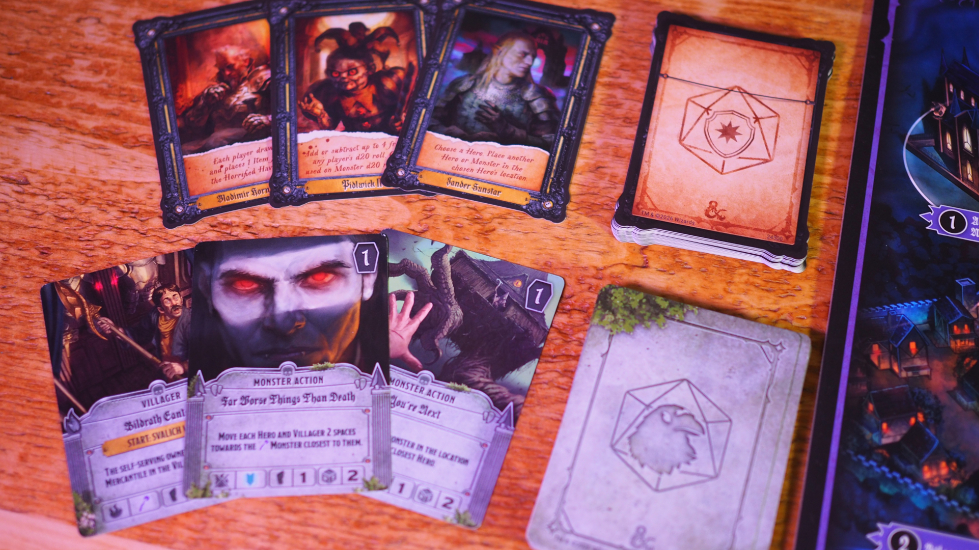 Cards from Horrified Ravenloft laid out on a wooden surface