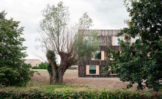 The reclaimed oak facade complements the natural surroundings