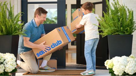 Father and Son picking up deliveries on their porch from Sam's Club 