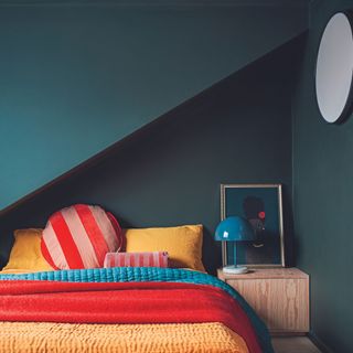 Green guest bedroom with bright bedding