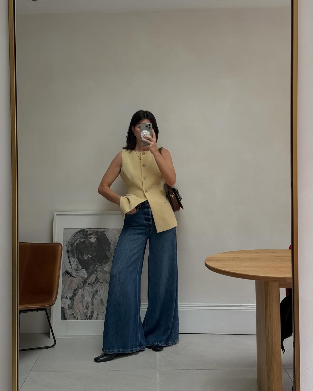 Francesca wearing a yellow blazer and wide-leg jeans.