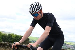 Image shows a rider cycling.