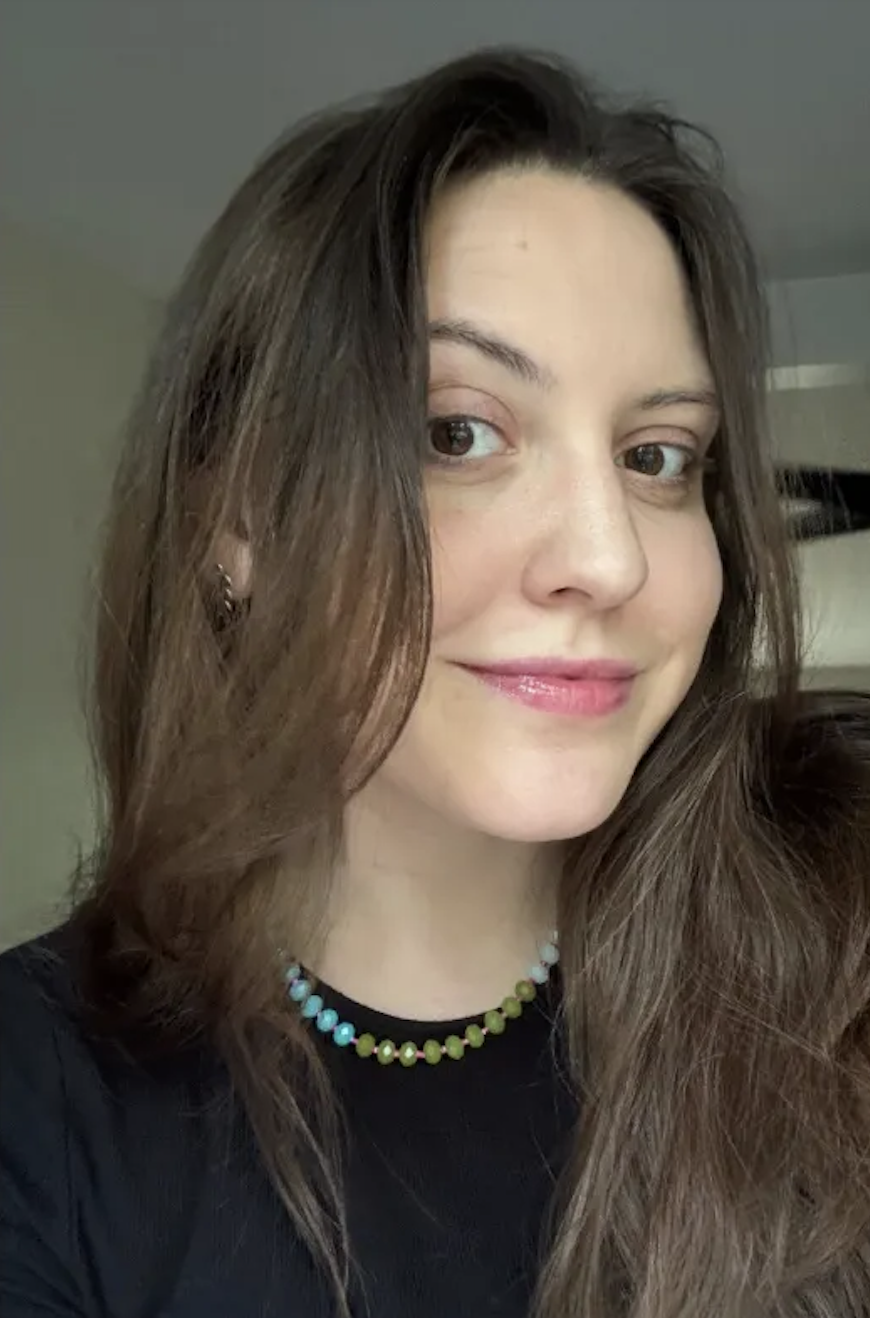 a girl with a black tshirt and clear skin after using the Anastasia Beverly Hills Beauty Balm Serum Boosted Skin Tint.