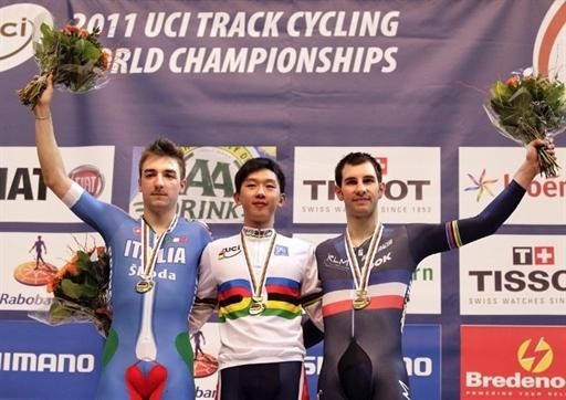 Ho Ting Kwok from Hongkong (C) on the scratch race podium as he celebrates his gold medal with second placed Italian lia Viviani and third-placed Morgan Kneisky of France