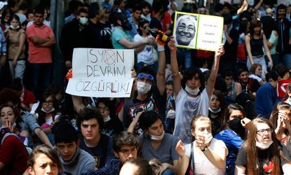 Turkish protesters hold up signs, including one that reads "rebellion, revolution, liberty," during demonstrations in Ankara on June 4. 