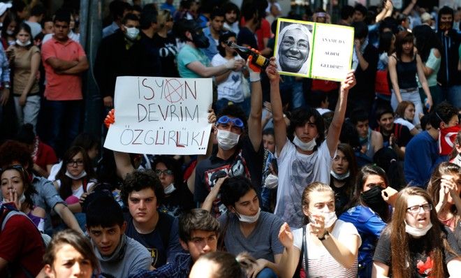 Turkish protesters hold up signs, including one that reads &amp;quot;rebellion, revolution, liberty,&amp;quot; during demonstrations in Ankara on June 4. 