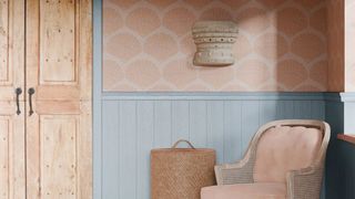 A bedroom decorated in blue wood panelling and coral shell wallpaper