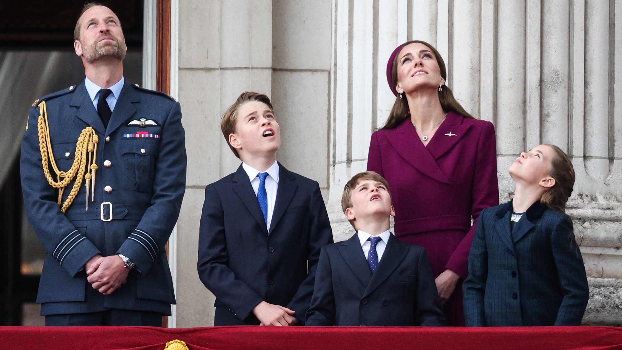 Prince William, Prince George, Prince Louis, Catherine, Princess of Wales and Princess Charlotte watch the Red Arrows flypast from Buckingham Palace on May 5, 2025 t
