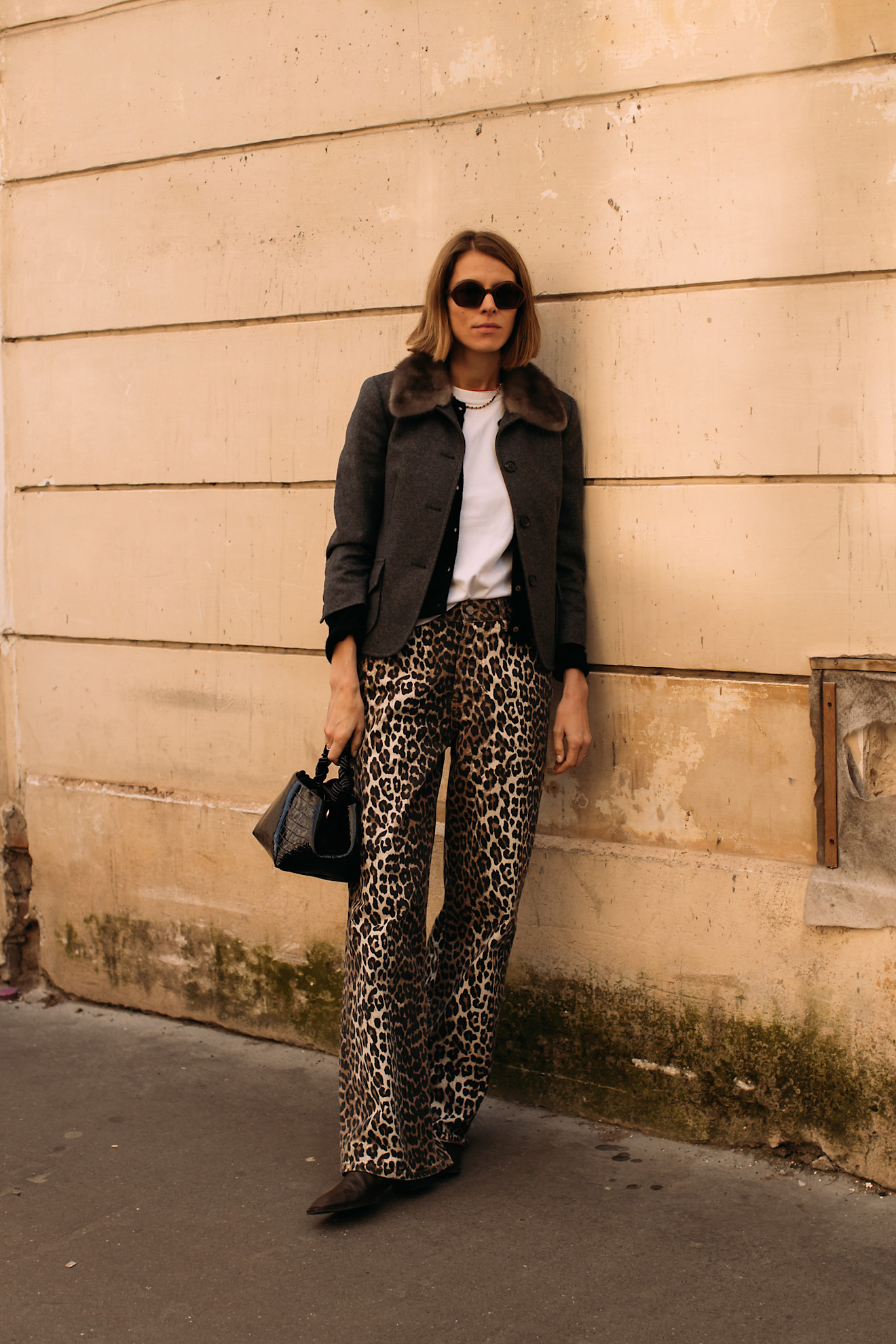 woman wearing leopard print pants and a work jacket in Paris