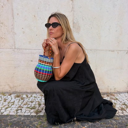@helenacanadas wears black maxi dress statement bag