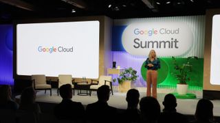 Anne-Marie Lamb, sales director UK & Ireland at Google Cloud, speaking onstage at Google Cloud Summit London 2024. Behind her is a stage with chairs and the Google Cloud logo.