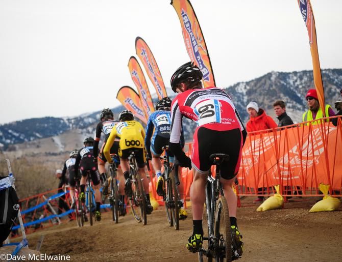 A long train of riders at the top of the course