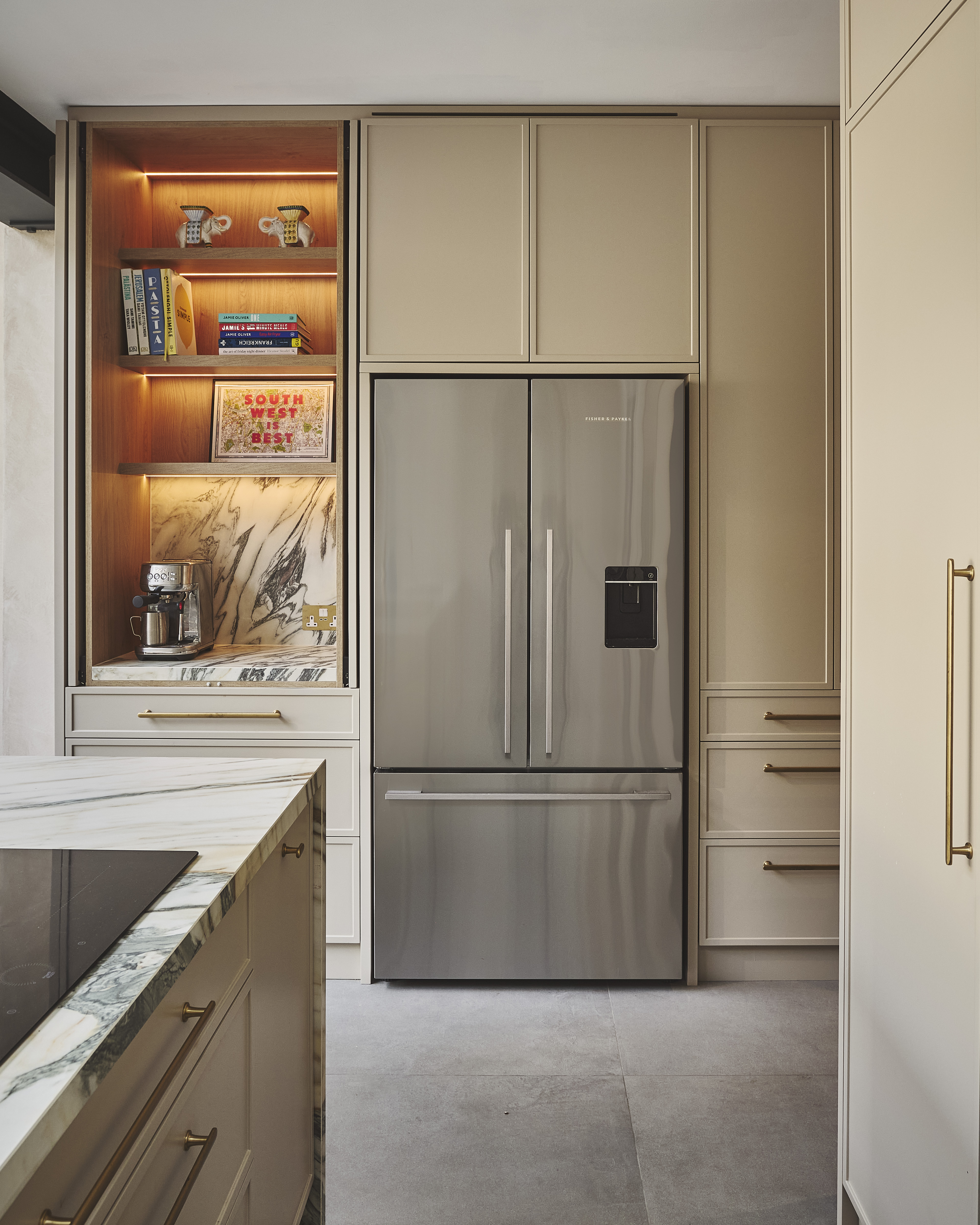 kitchen with neutral colored cabinetry and an open pocket door breakfast station with under shelf lighting