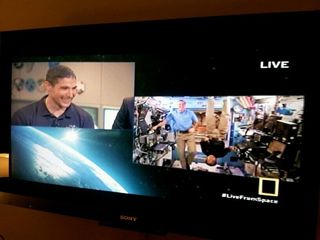 NASA astronaut Mike Hopkins (left) at NASA's Mission Control in Houston chats with fellow NASA astronaut Rick Mastracchio (right in blue shirt) and Japanese astronaut Koichi Wakata while the two men were still floating in weightlessness on the International Space Station. Hopkins returned to Earth on March 10, 2014, but spoke here with the station crew on during the National Geographic Channel's "Live From Space" event on March 14.