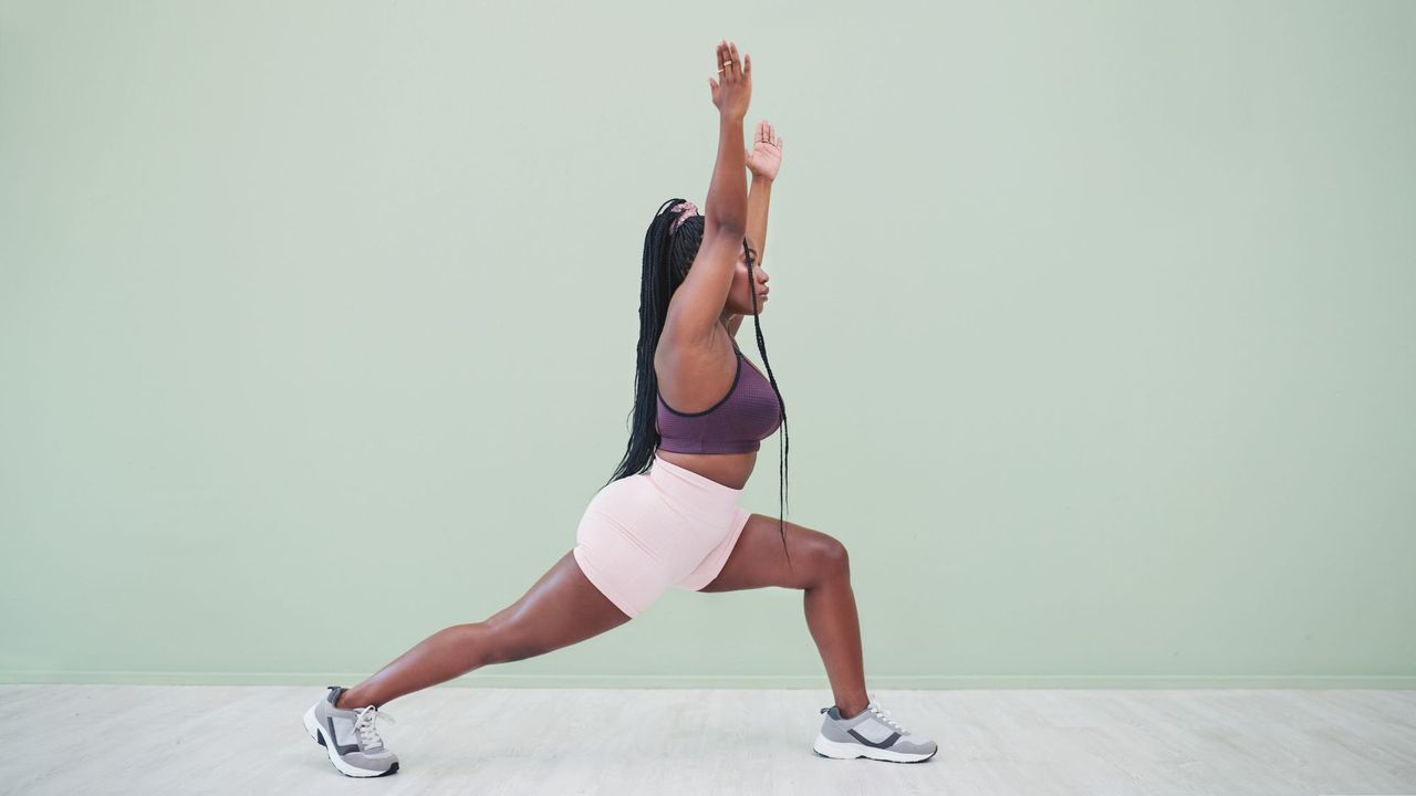 A woman doing a forward lunge