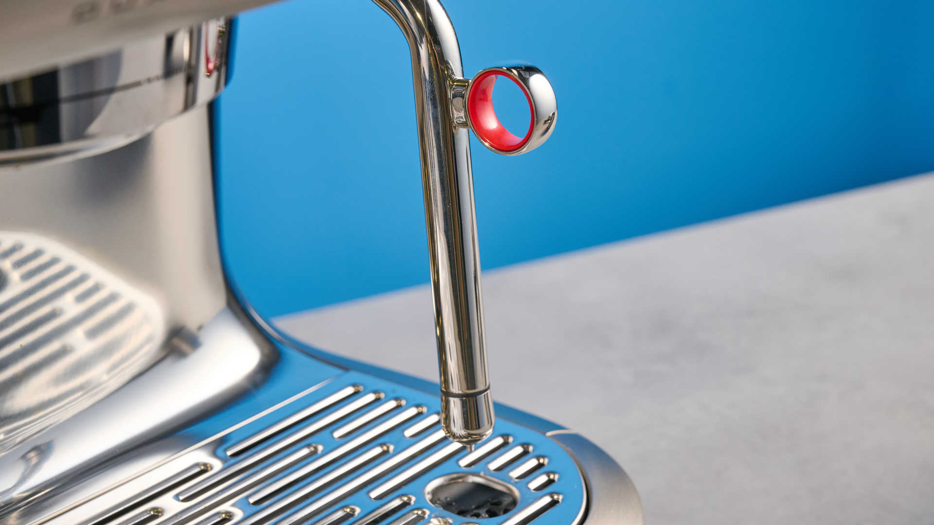 the breville oracle dual boiler / sage oracle dual boiler in stainless steel, showing its touchscreen, steam wand, built in grinder, and espresso shots